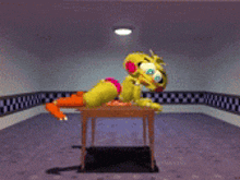 chica the chicken is laying on a table in a room