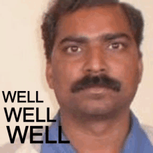 a man with a mustache is standing in front of a well well well sign