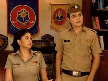 a man and a woman in military uniforms are standing in front of a banner that says ' government '