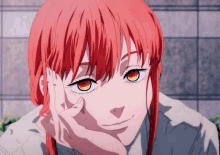 a girl with red hair and yellow eyes is smiling