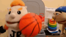 a stuffed animal with the letter jr on its shirt is holding a basketball