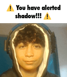 a young man wearing headphones has a warning sign above his head that says " you have alerted shadow !!! "