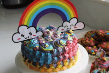 a colorful cake with a rainbow and clouds on it