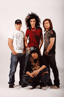 a group of young men are posing for a photo and one of them is wearing a hat that says cream