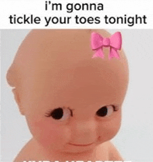 a baby doll with a pink bow on its head is being tickled .