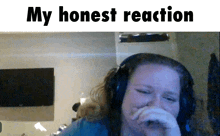 a woman wearing headphones covering her mouth with her hand and the words my honest reaction