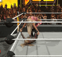 a woman in a wrestling ring with the letter w on her pants