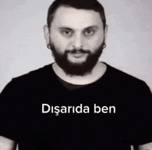 a man with a beard is wearing a black shirt that says disarida ben on it