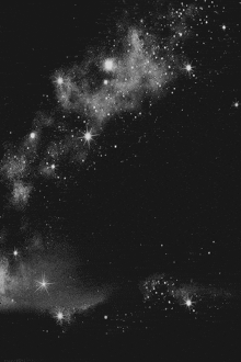 a black and white photo of a starry sky