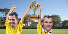 two men holding a trophy that says regular season hero on it