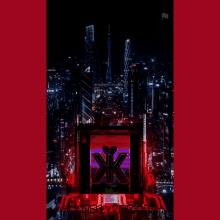 a red sign with the letter k on it in front of a city