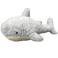 a stuffed shark with a white tail is laying on a white background