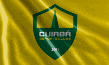 a green shield with the words cuiaba esporte clube 2001 on a yellow background