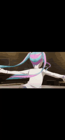 a girl with pink and blue hair is standing with her arms outstretched in a room .