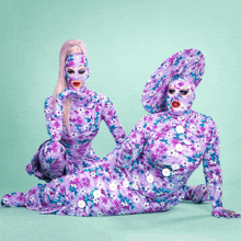 two women in purple floral costumes with white buttons