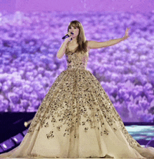 a woman in a gown singing into a microphone