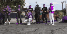 a group of men wearing purple clothes and masks are standing in front of a purple car