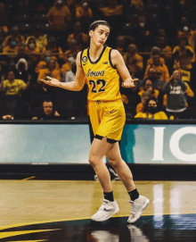 a female basketball player wearing a yellow jersey with the number 22 on it