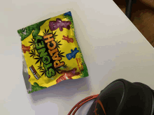 a bag of stone patches sits on a table next to headphones