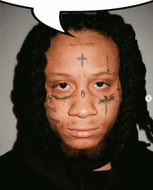 a man with dreadlocks has a cross on his forehead and the number 8 on his face