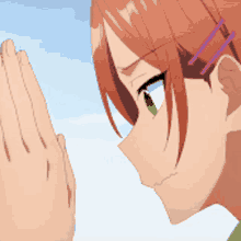 a girl with red hair and green eyes is praying with her hands folded