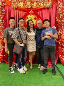 a group of people posing for a picture including one wearing a shirt that says tommy