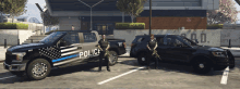 two police officers standing next to a truck that says police