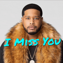 a man wearing a fur coat with the words " i miss you " on it