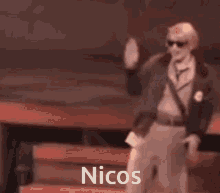 a man in a suit and tie is dancing with his arms outstretched and the word nicos is on the bottom of the image