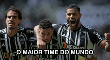 a group of soccer players are celebrating a win with the caption " o maior time do mundo "