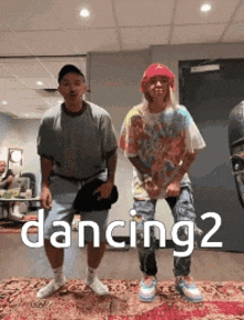 two men are dancing in a room with the words dancing 2 written on the bottom