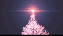 a pink christmas tree with a light coming out of it