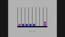 a computer screen shows purple and blue balls and the words you win at the bottom