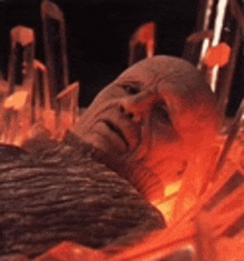 a man is laying in a pile of lava with his face visible .