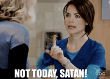 a woman says " not today satan " while pointing her finger at another woman