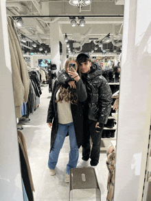 a man and a woman are taking a picture in a dressing room