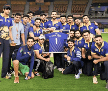 a group of men are posing for a picture with a shirt that says 1 on it