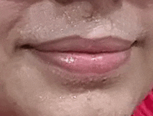 a close up of a woman 's lips with a red lipstick on .