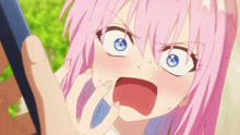 a girl with pink hair and blue eyes is making a face