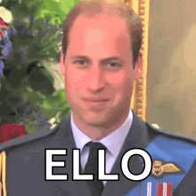 a close up of a man in a suit and tie with the word " ello " written on his face .