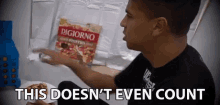 a man is holding a bag of digiorno pizza and says this doesn 't even count