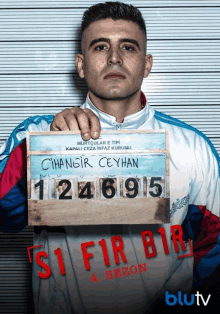 a man holding up a sign that says cihangir ceyhan