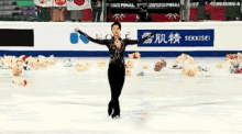 a man is skating on a rink with his arms outstretched in front of a crowd .