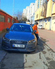 a gray audi with a license plate that says 34 kj 6984