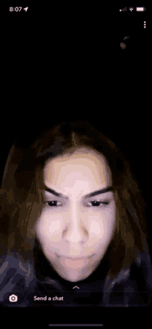 a woman 's face is visible on a phone screen .