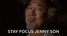 a man with a beard says " stay focus jenny son " in a dark room