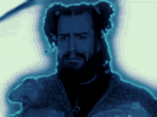 a man with dreadlocks and a beard has a blue glow around his face