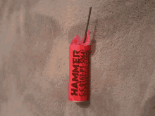 a red hammer firework sitting on a carpet