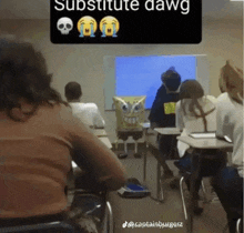 a group of students sit in a classroom with a spongebob doll in front of them