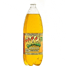 a bottle of bigga jamaica ale is sitting on a white surface